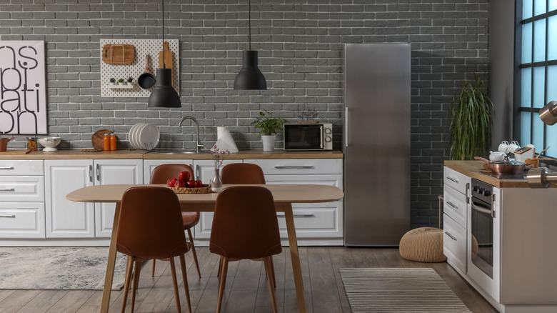 A kitchen with a stainless steel fridge and stove