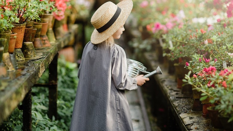 Little girl tending to azaleas 