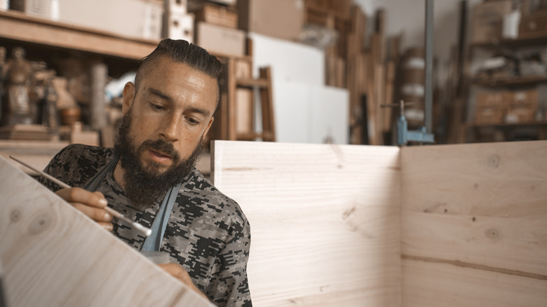 A man using wood glue to repair wood