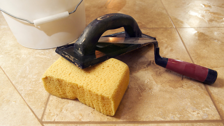 The tools of a marble mason set out on a marble floor