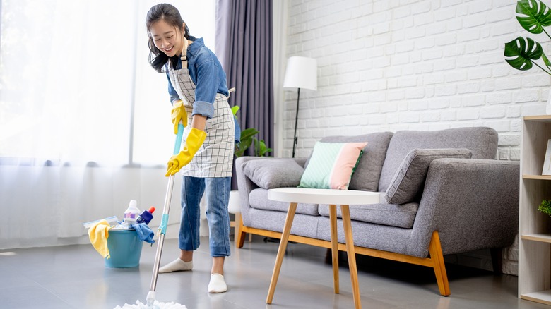 Woman smiling while mopping