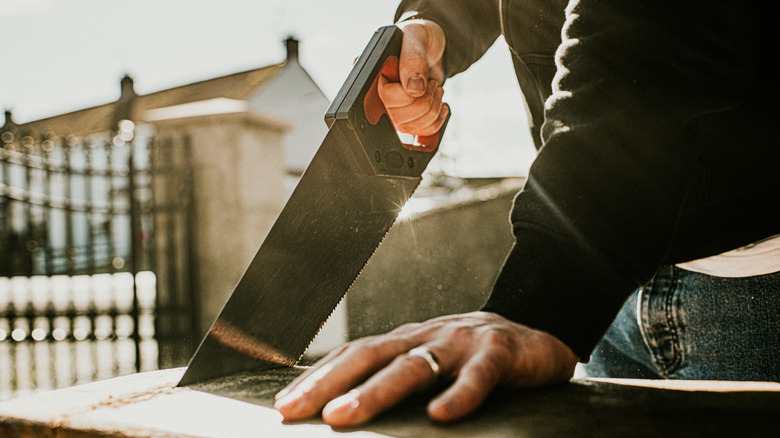 hand saw cutting wood