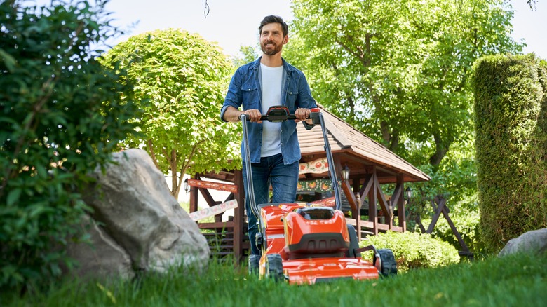 man mows lawn 