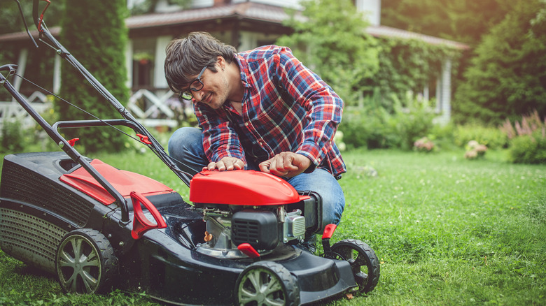 man observes lawn mower 