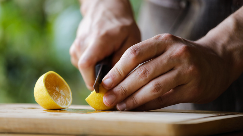 person cutting lemon