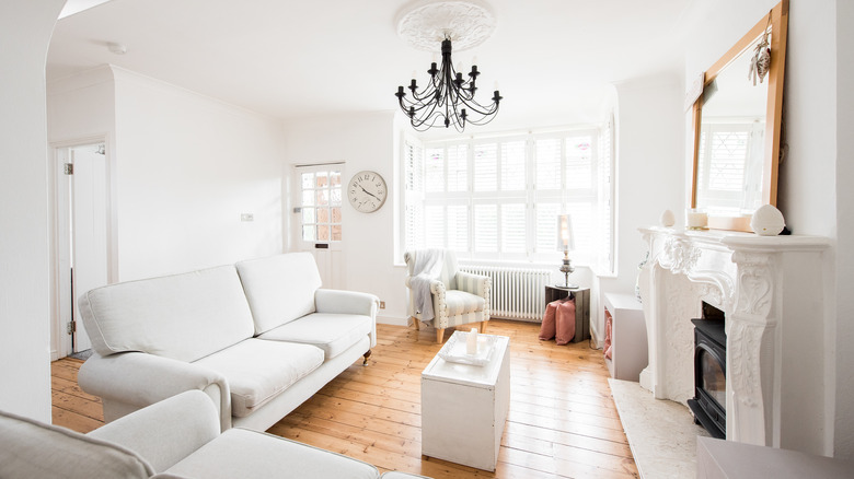 Stark white living room with black chandelier