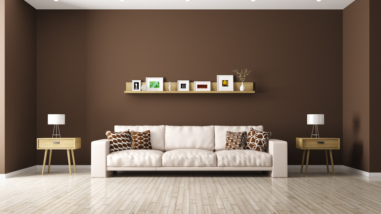 Dark brown living room with cream colored couch