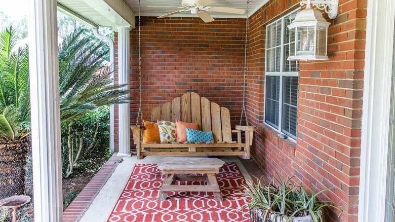 front porch swing and rug