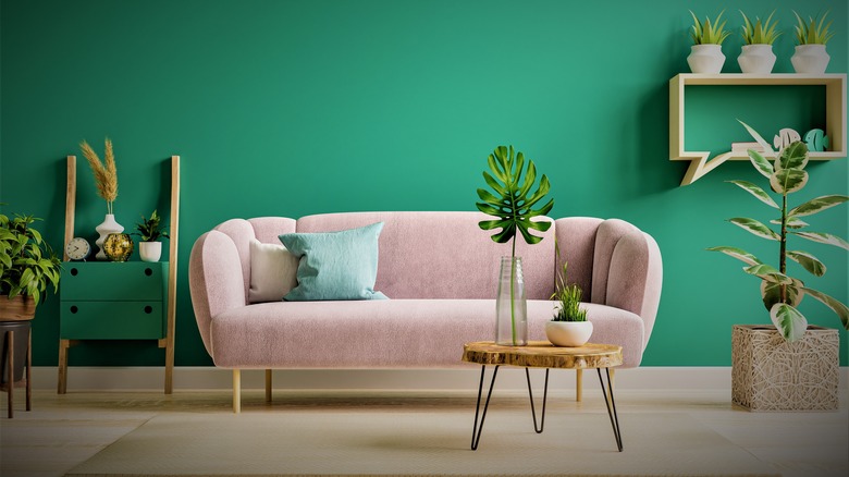 Green room with pink sofa