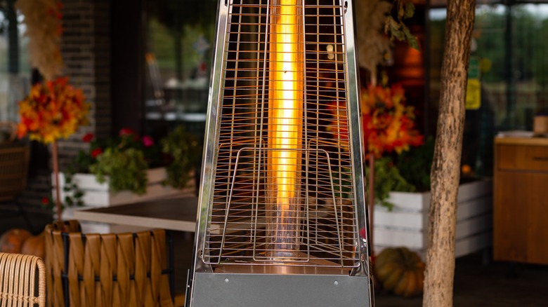 A warm heat lamp on an outdoor patio space.