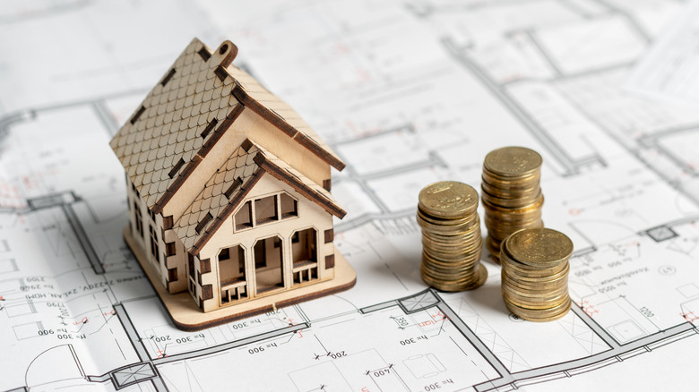 Model home and stacked coins