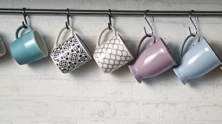 Coffee mugs on wall hooks