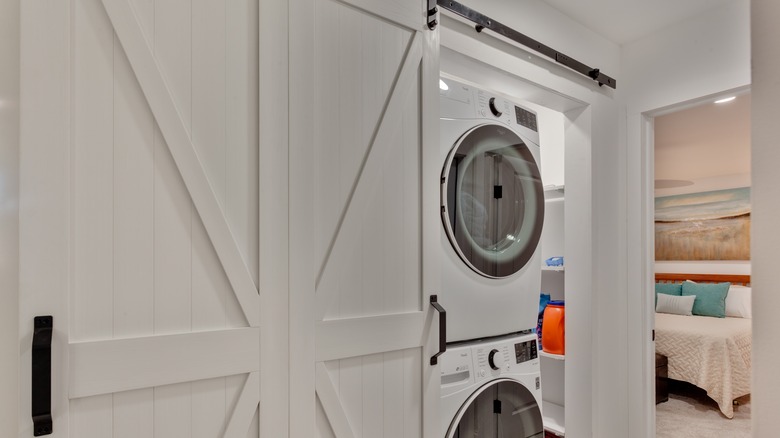 laundry area with barn door