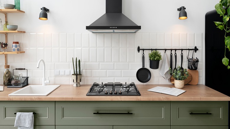 kitchen with muted green cabinets