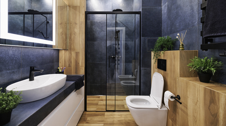 Deep violet walls in a bathroom with wood accents