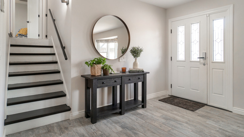 An entryway with nearby stairs and a table