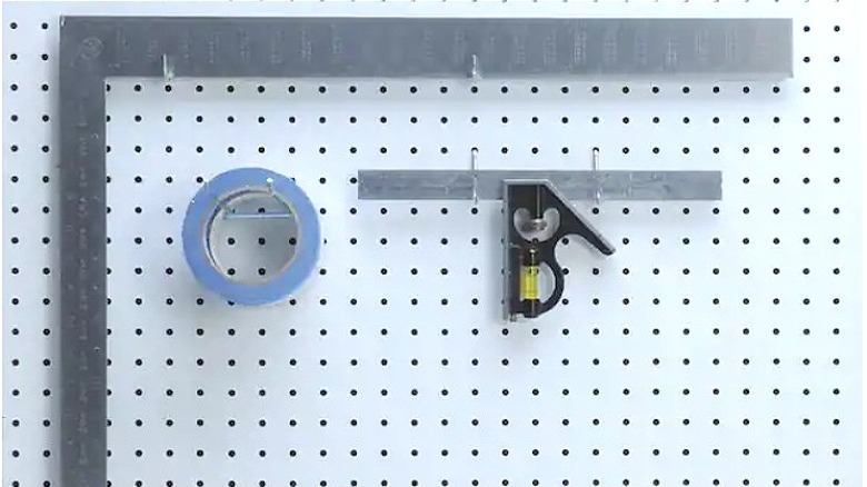 white peg board with tools