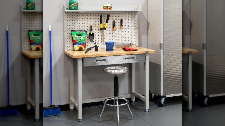 workbench with pegboard and stool