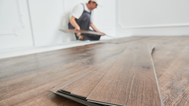 Man installing vinyl flooring