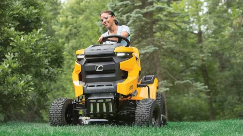 A person riding a Cub Cadet riding mower