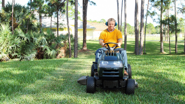 A man on a riding lawn mower