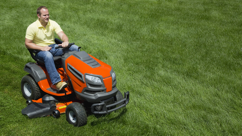 A person on a riding lawn mower