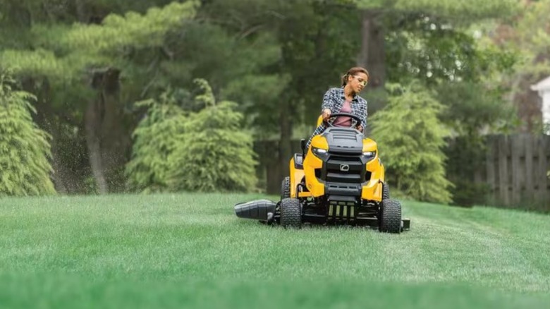 A person riding a Cub Cadet riding mower