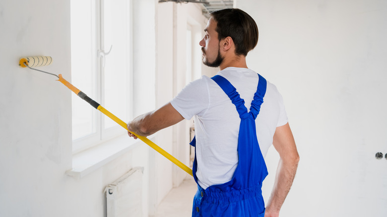 Man painting hallway 