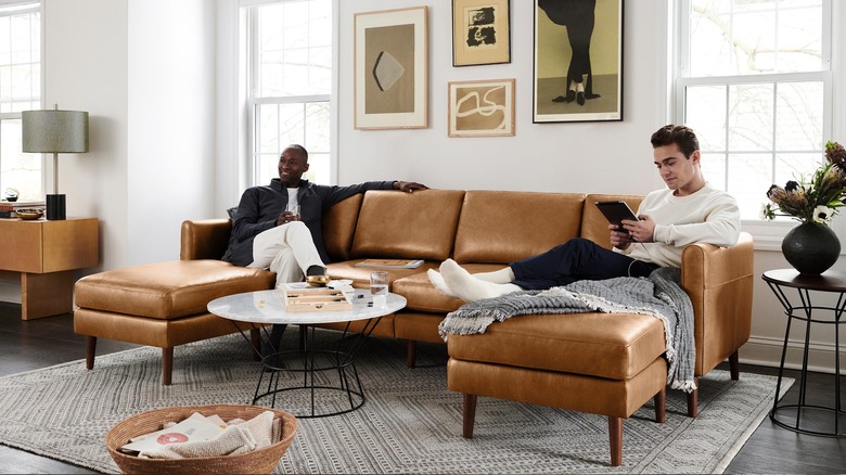 two men on leather sectional sofa