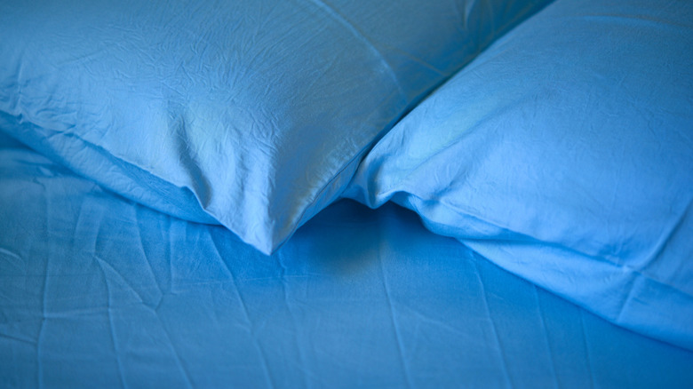 blue bed sheets and pillows