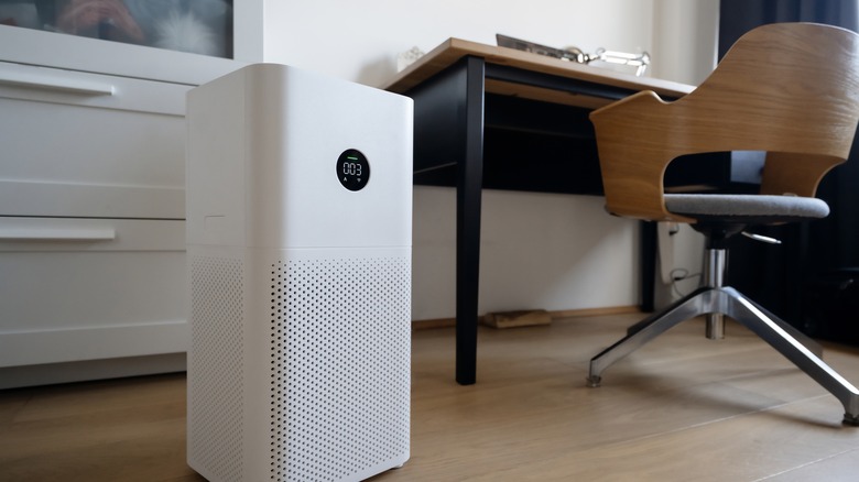 Air purifier next to desk