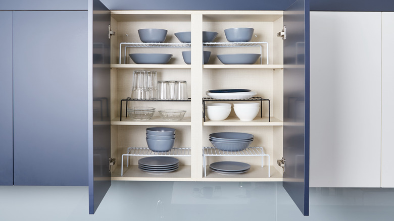 A cabinet with organized dinnerware