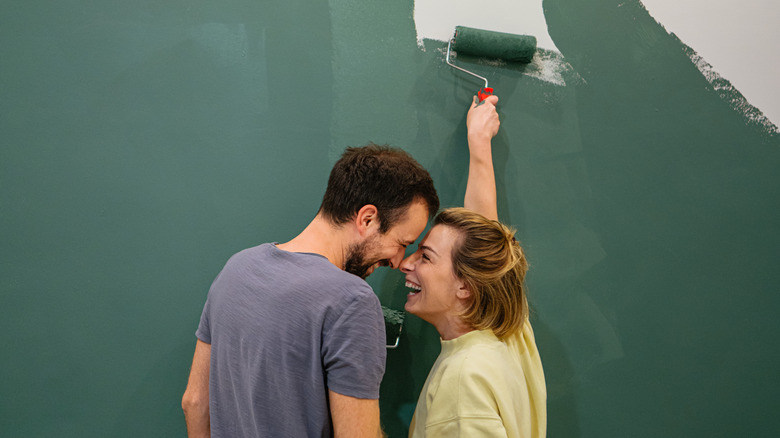 couple painting apartments walls