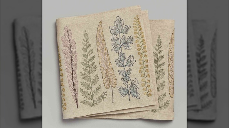 Folded embroidered botanical table runner