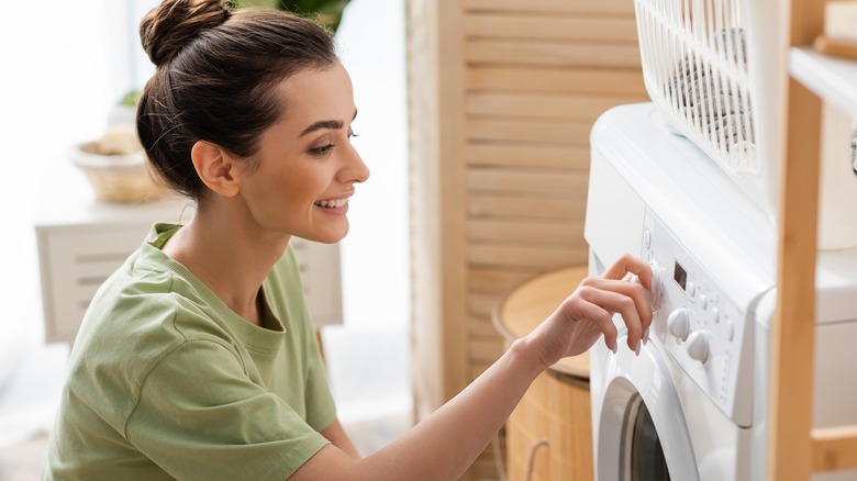 Woman setting the washing temperature 