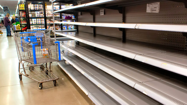 shopping cart by empty shelves