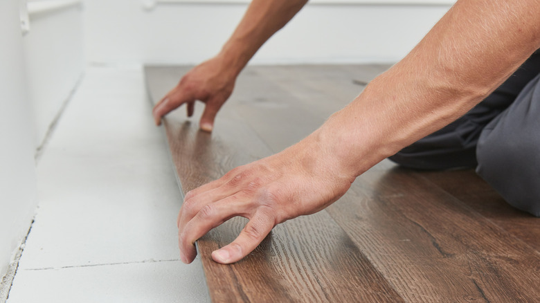 Man installing vinyl tiles