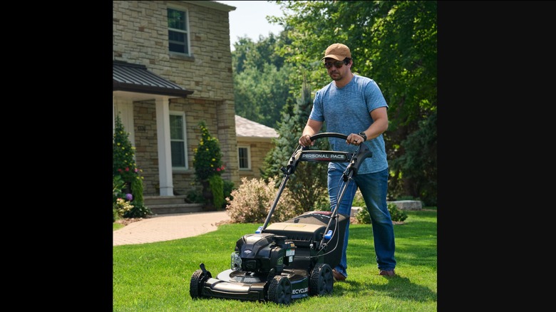 person pushing toro lawn mower