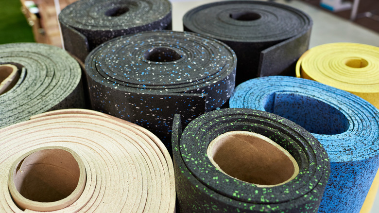 Rolls of rubber backing or underlayment for vinyl plank flooring