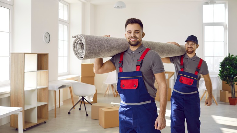 handymen holding carpet