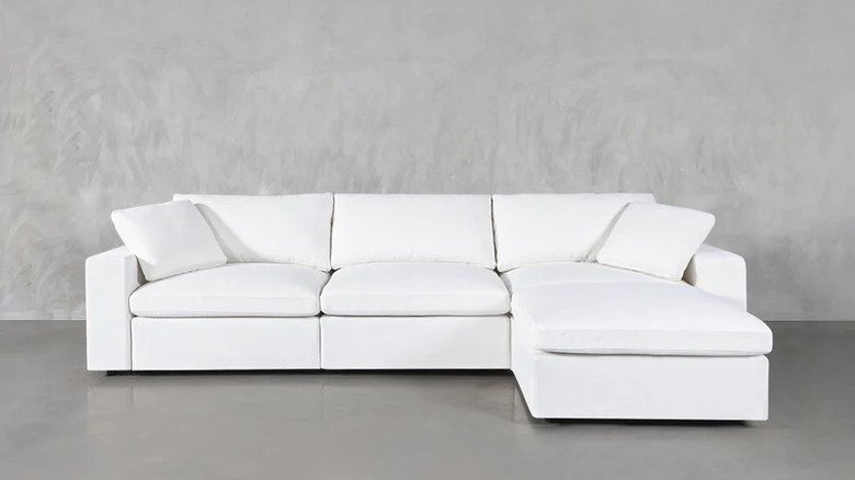 White L-shaped sectional couch grey room