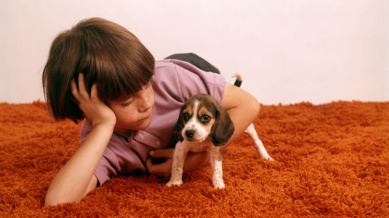 boy and dog on carpet