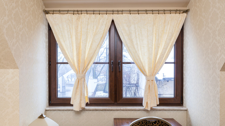 Curtains on a tension rod covering a window