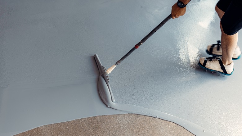 Person painting concrete floor