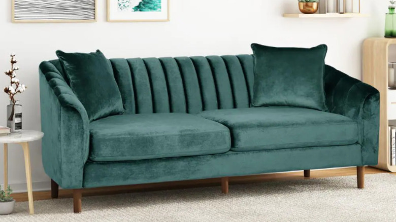 Teal velvet couch in living room