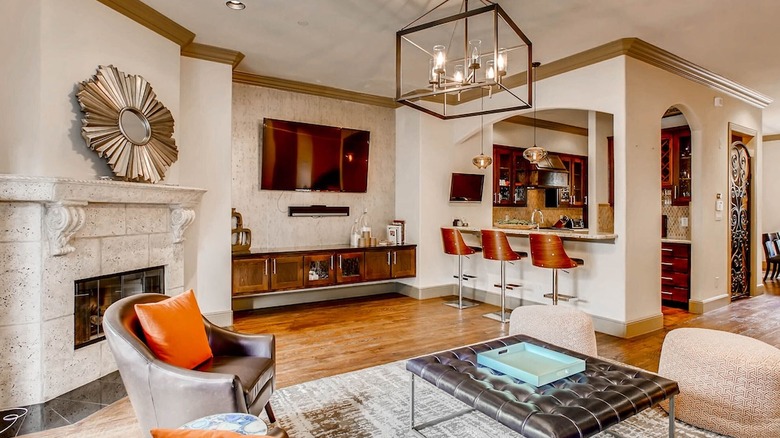 sleek living room with orange pillows