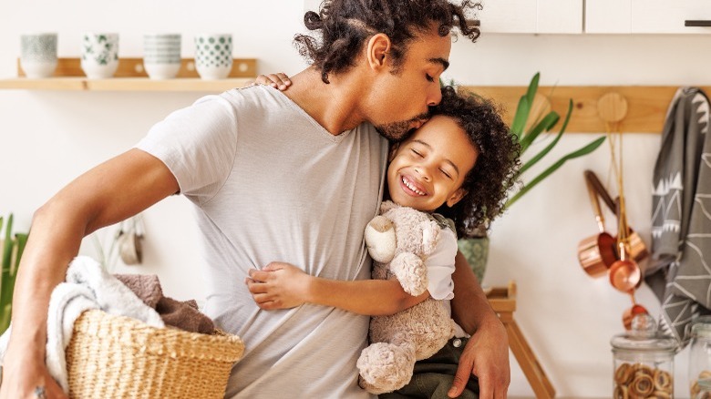 Dad and kid with laundry basket