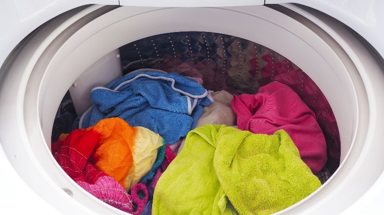 colorful clothes in top load washer
