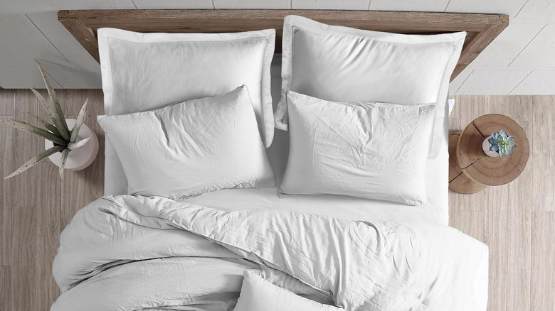 white bed coverings and pillows