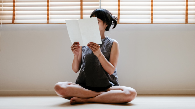 woman reading instructions sheet